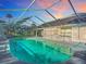 Inviting screened oval pool with surrounding patio at 2322 Melonie Trl, New Smyrna Beach, FL 32168