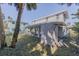 Large backyard with patio, grass, and palm trees at 239 Kirkland Rd, New Smyrna Beach, FL 32169