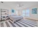 Bright bedroom with a comfortable bed and striped rug at 239 Kirkland Rd, New Smyrna Beach, FL 32169