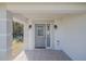 Gray front door with glass panels and sidelights at 239 Kirkland Rd, New Smyrna Beach, FL 32169