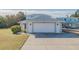 White garage door and driveway of a beach house at 239 Kirkland Rd, New Smyrna Beach, FL 32169