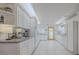 Bright kitchen with white cabinets and granite counters at 239 Kirkland Rd, New Smyrna Beach, FL 32169