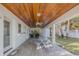 Covered patio with wood ceiling, table and chairs at 239 Kirkland Rd, New Smyrna Beach, FL 32169