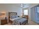 Bedroom with a queen-size bed, desk and balcony access at 3 Riverwalk Dr # 302, New Smyrna Beach, FL 32169