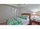 Guest bedroom with green bedding and ensuite closet at 3 Riverwalk Dr # 302, New Smyrna Beach, FL 32169