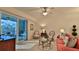 Bright living room with coral sofa and access to balcony at 3 Riverwalk Dr # 302, New Smyrna Beach, FL 32169