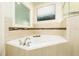 Spa-like bathroom featuring a corner soaking tub and window at 3 Riverwalk Dr # 401, New Smyrna Beach, FL 32169