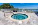 Circular hot tub with surrounding patio and water views at 3 Riverwalk Dr # 401, New Smyrna Beach, FL 32169