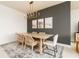 Bright dining room with a wooden table, rattan chairs, and a modern chandelier at 3 Riverwalk Dr # 401, New Smyrna Beach, FL 32169