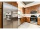 Stainless steel appliances and wood cabinets in this modern kitchen at 3 Riverwalk Dr # 401, New Smyrna Beach, FL 32169