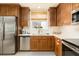 Modern kitchen with wood cabinets, quartz countertops and a farmhouse sink at 3 Riverwalk Dr # 401, New Smyrna Beach, FL 32169