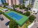 Community tennis court with green and blue surface at 3 Riverwalk Dr # 401, New Smyrna Beach, FL 32169