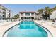 Large community pool with surrounding lounge chairs at 3001 S Atlantic Ave # 503, New Smyrna Beach, FL 32169