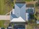 Aerial view of a house with gray metal roof, pool, and fenced backyard at 3015 Queen Palm Dr, Edgewater, FL 32141