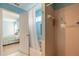 Bathroom with shower, tub, and view into bedroom at 3015 Queen Palm Dr, Edgewater, FL 32141