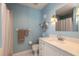 Clean bathroom with white vanity, shower, and light blue walls at 3015 Queen Palm Dr, Edgewater, FL 32141