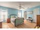 Bedroom with light blue walls, a metal bed frame, and hardwood floors at 3015 Queen Palm Dr, Edgewater, FL 32141