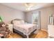 Bedroom with a queen-size bed, light gray walls, and wood floors at 3015 Queen Palm Dr, Edgewater, FL 32141