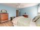 Bedroom featuring light blue walls, hardwood floors, and antique furniture at 3015 Queen Palm Dr, Edgewater, FL 32141