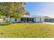 Light teal house with a metal roof and small front yard at 3015 Queen Palm Dr, Edgewater, FL 32141