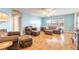 Living room boasts hardwood floors, light blue walls and ample seating at 3015 Queen Palm Dr, Edgewater, FL 32141