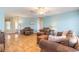 Living room with hardwood floors, light blue walls, and comfy brown leather furniture at 3015 Queen Palm Dr, Edgewater, FL 32141