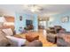 Bright living room with light blue walls and comfortable brown leather furniture at 3015 Queen Palm Dr, Edgewater, FL 32141