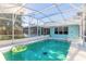 Inviting screened-in pool with a fun inflatable ring at 3015 Queen Palm Dr, Edgewater, FL 32141