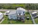 Elevated view of home, deck, and surrounding landscape at 303 River Rd, Oak Hill, FL 32759