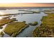 Aerial view showcasing waterfront property and lush landscape at 303 River Rd, Oak Hill, FL 32759