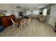 Bright living room featuring a sectional sofa and wood-look floors at 303 River Rd, Oak Hill, FL 32759