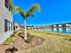 Landscaped backyard with a palm tree and a view of a lake at 3035 Meleto Blvd, New Smyrna Beach, FL 32168