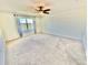 Spacious bedroom with large window and ceiling fan at 3035 Meleto Blvd, New Smyrna Beach, FL 32168