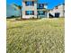 Two-story house with gray siding, burgundy shutters, and a spacious lawn at 3035 Meleto Blvd, New Smyrna Beach, FL 32168