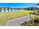 Lakefront property with a paved walkway and lush landscaping at 3035 Meleto Blvd, New Smyrna Beach, FL 32168