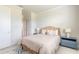 Light and airy bedroom with a wicker bed frame and neutral decor at 3066 Isles Way, New Smyrna Beach, FL 32168