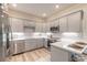 Modern kitchen with stainless steel appliances and gray cabinets at 3066 Isles Way, New Smyrna Beach, FL 32168