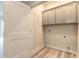 Bright laundry room with upper cabinets and vinyl flooring at 3066 Isles Way, New Smyrna Beach, FL 32168