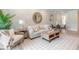 Living area with light-colored sofa and round mirror at 3066 Isles Way, New Smyrna Beach, FL 32168