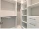 Large walk-in closet with shelves and hanging rods at 3066 Isles Way, New Smyrna Beach, FL 32168