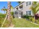 Landscaped backyard with tropical plants and screened porch at 3067 Isles Way, New Smyrna Beach, FL 32168