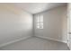 Simple bedroom with carpet, window with shutters and a door at 3067 Isles Way, New Smyrna Beach, FL 32168