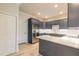 Modern kitchen with dark gray cabinets and quartz countertops at 3067 Isles Way, New Smyrna Beach, FL 32168