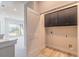 Laundry closet with upper cabinets and flooring at 3067 Isles Way, New Smyrna Beach, FL 32168