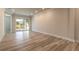 Bright living room with wood-look flooring and sliding glass doors at 3067 Isles Way, New Smyrna Beach, FL 32168