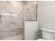 Walk-in shower with marble tile and glass enclosure at 3067 Isles Way, New Smyrna Beach, FL 32168