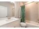 Clean bathroom with white vanity, bathtub, and green shower curtain at 3088 Isles Way, New Smyrna Beach, FL 32168