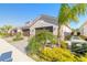 Tan house with two-car garage and tropical landscaping at 3088 Isles Way, New Smyrna Beach, FL 32168