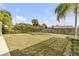 Large backyard with grassy lawn and palm trees at 3103 Royal Palm Dr, Edgewater, FL 32141