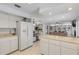 Kitchen features granite counters, white cabinets, and a view of the living room at 3103 Royal Palm Dr, Edgewater, FL 32141